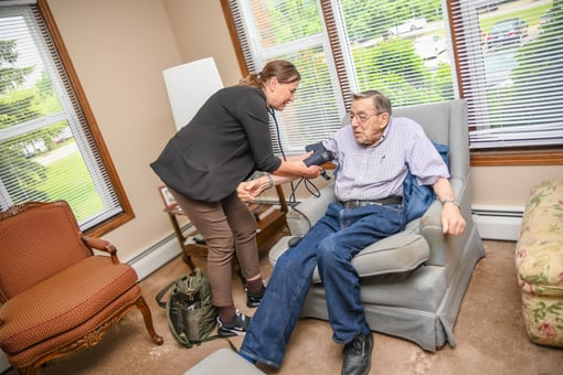 Staff taking Bob's blood pressure