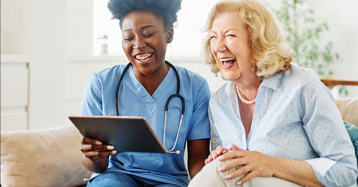 memory care nurse and resident bonding and laughing